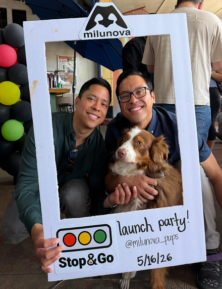 Saul and Erik at the Milunova launch party holding the Stop & Go sign and a foster dog