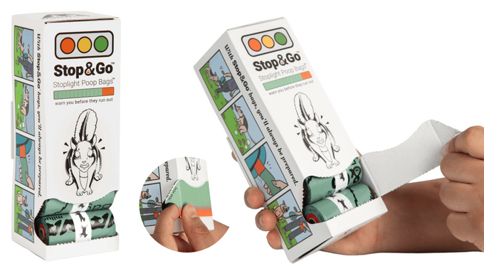 A finger tearing the "TEAR HERE" perforated window on the Stop & Go dispenser box to release the rolls